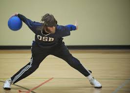 goalball player hurling ball